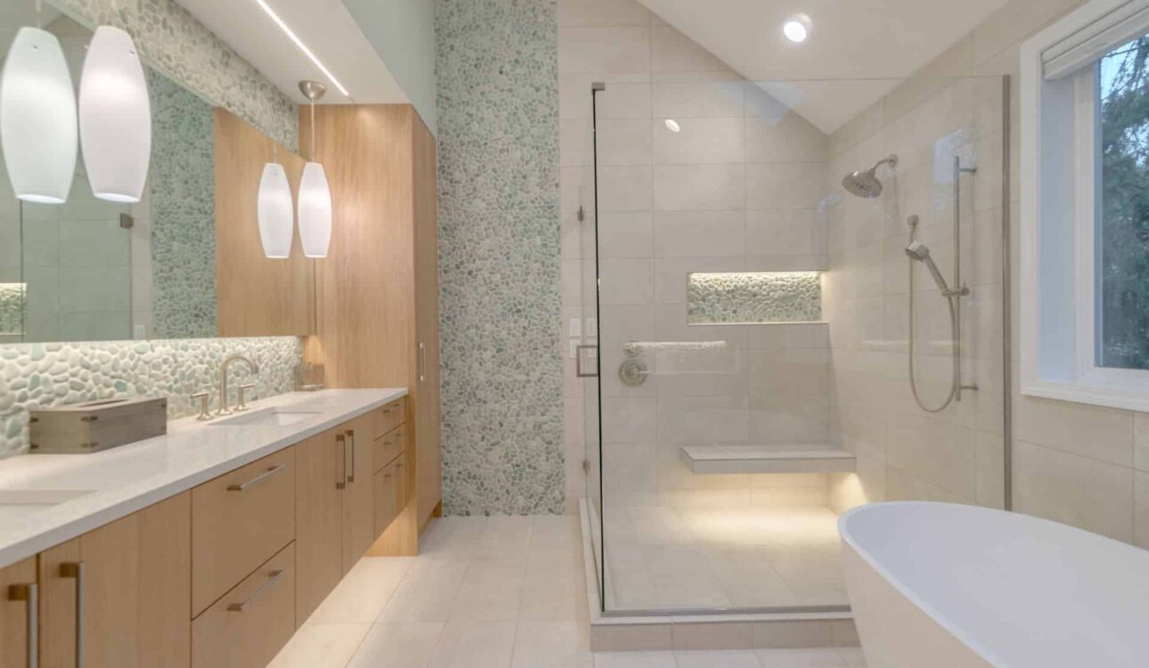 Contemporary bathroom featuring a glass-enclosed shower, freestanding bathtub, and wood vanity