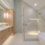 Contemporary bathroom featuring a glass-enclosed shower, freestanding bathtub, and wood vanity