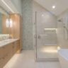 Contemporary bathroom featuring a glass-enclosed shower, freestanding bathtub, and wood vanity