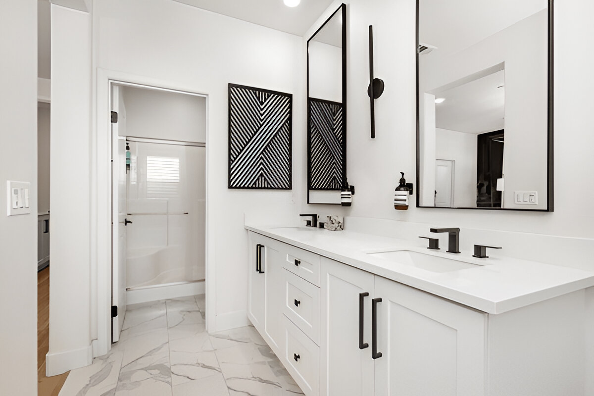 Modern white bathroom with black fixtures and double vanity