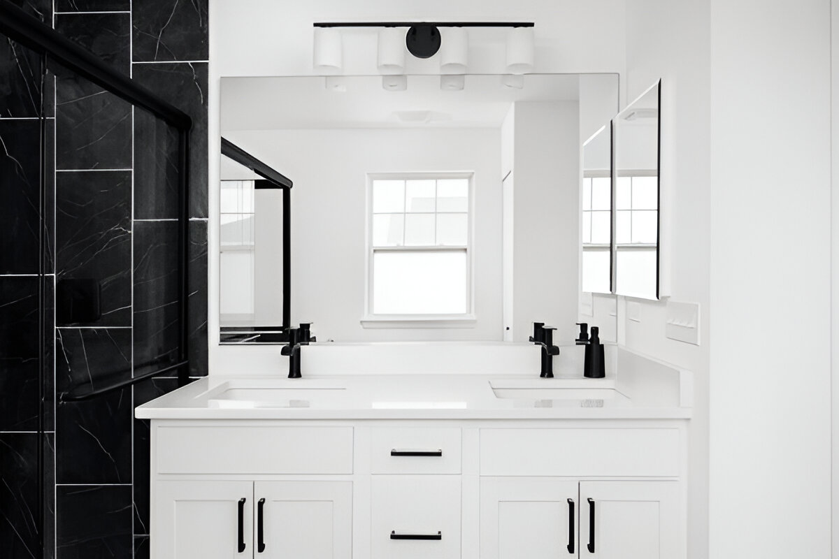  Black and white bathroom with double vanity and large mirror