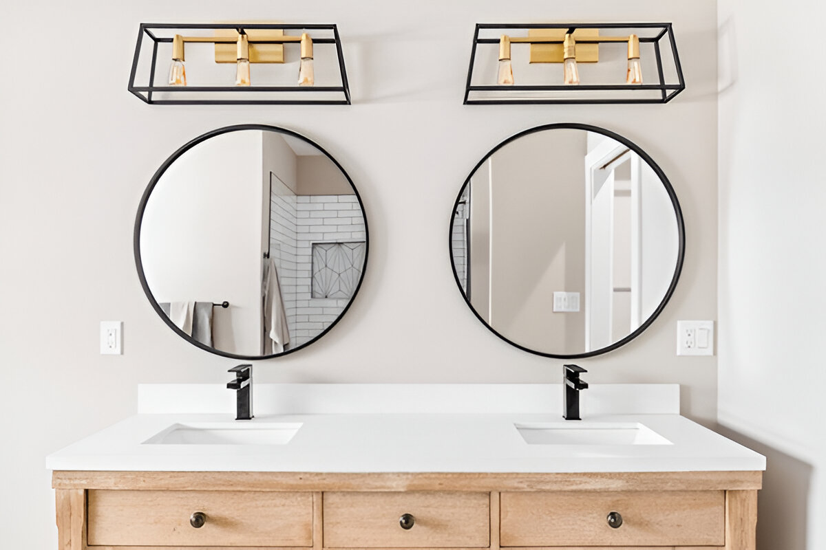 Double sink vanity with round mirrors and modern black faucets