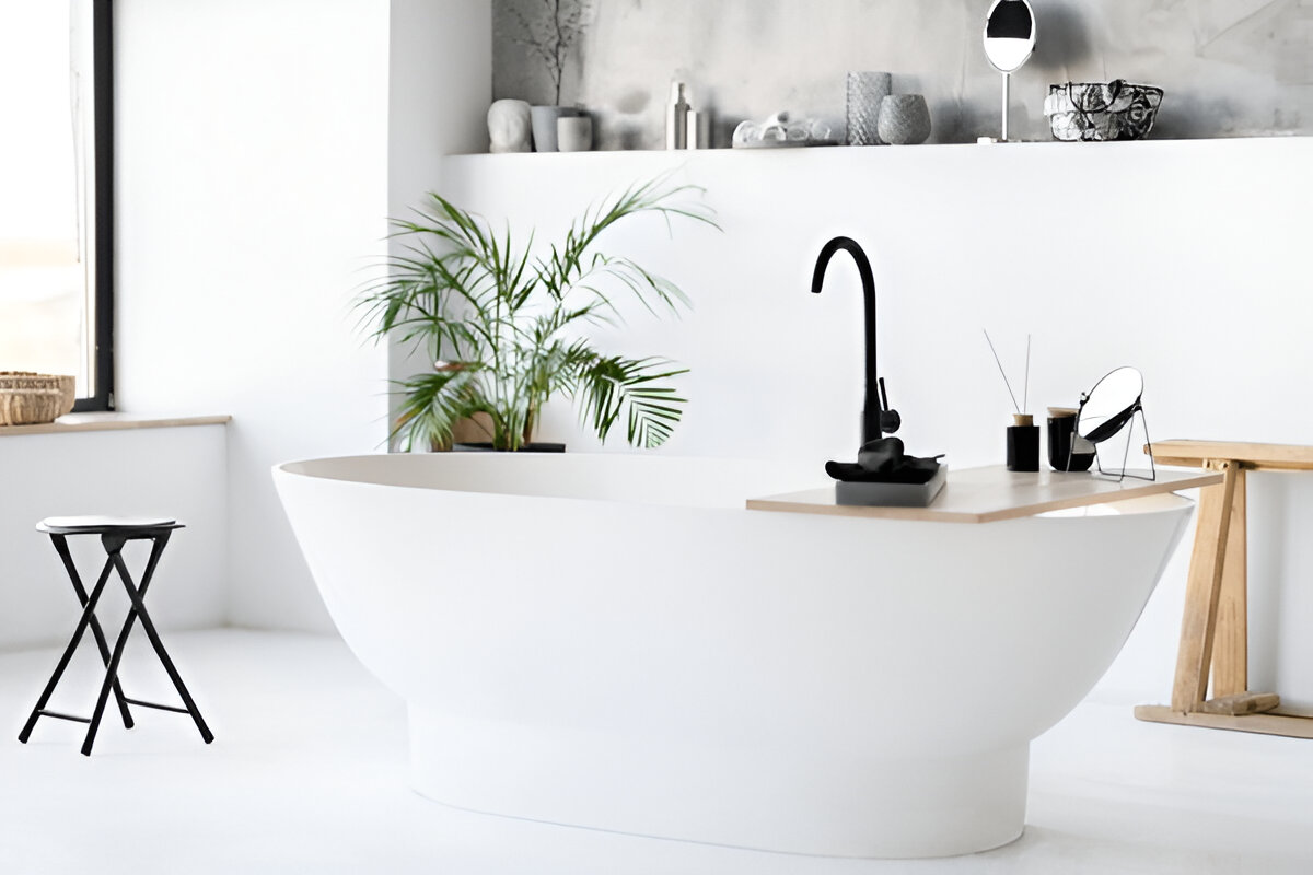 Minimalist bathroom with freestanding tub and black faucet