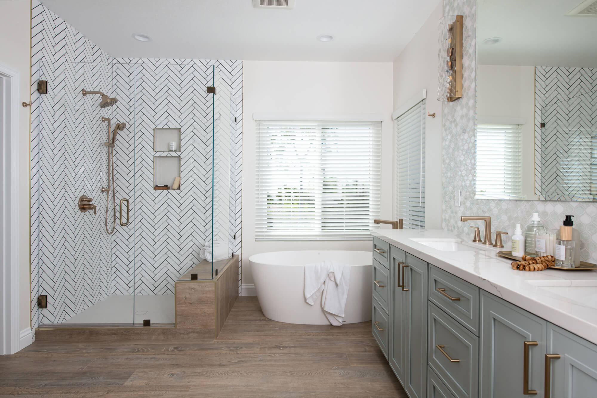 Bathroom with glass shower, freestanding tub, and modern double vanity
