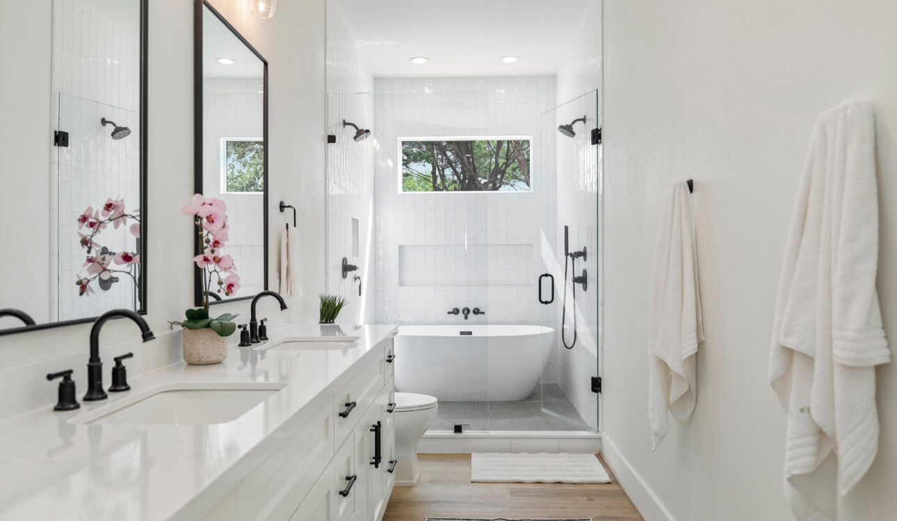 Modern bathroom with double vanity and glass shower enclosure
