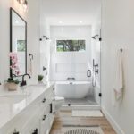 Modern bathroom with double vanity and glass shower enclosure
