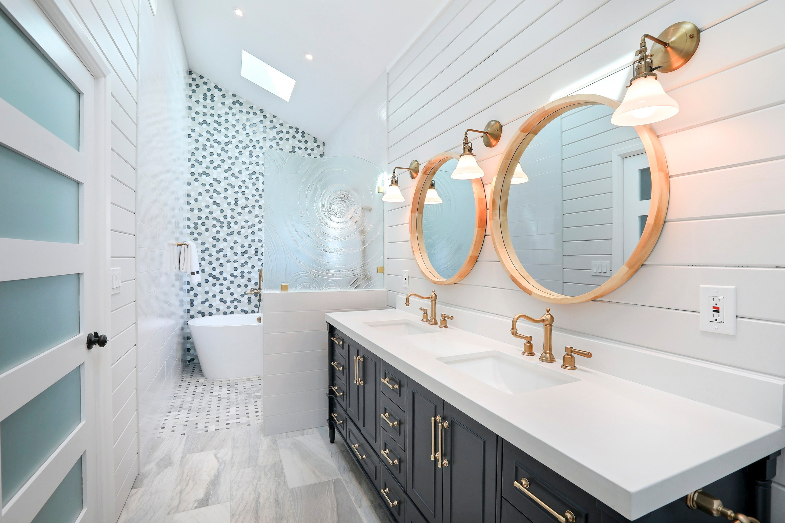 Stylish bathroom with double vanity and round mirrors