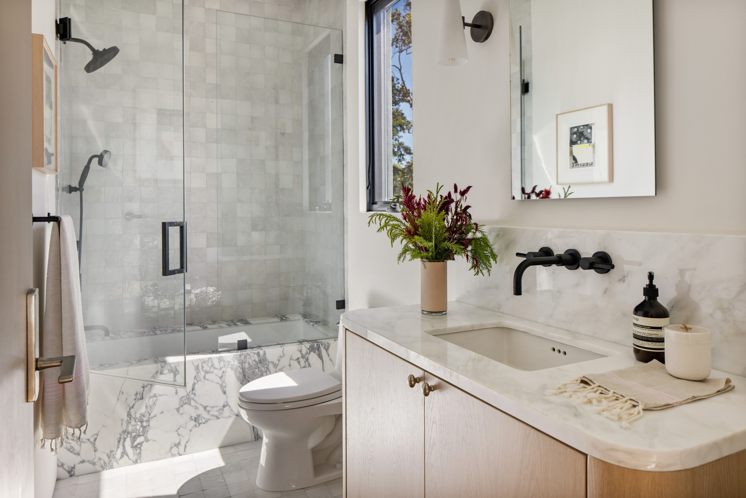 Elegant bathroom with marble accents and glass-enclosed shower
