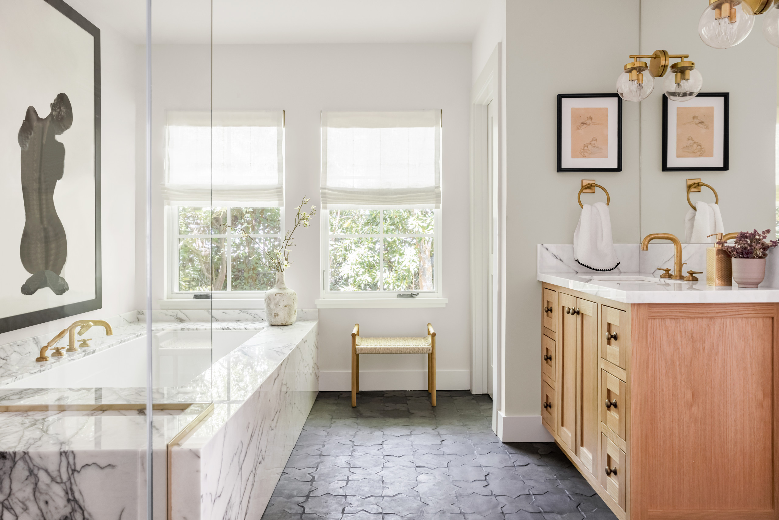 Luxurious bathroom with marble bathtub and natural wood vanity
