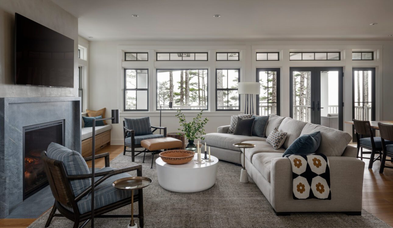 Modern living room with fireplace and large windows.