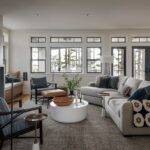 Modern living room with fireplace and large windows.