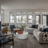 Modern living room with fireplace and large windows.