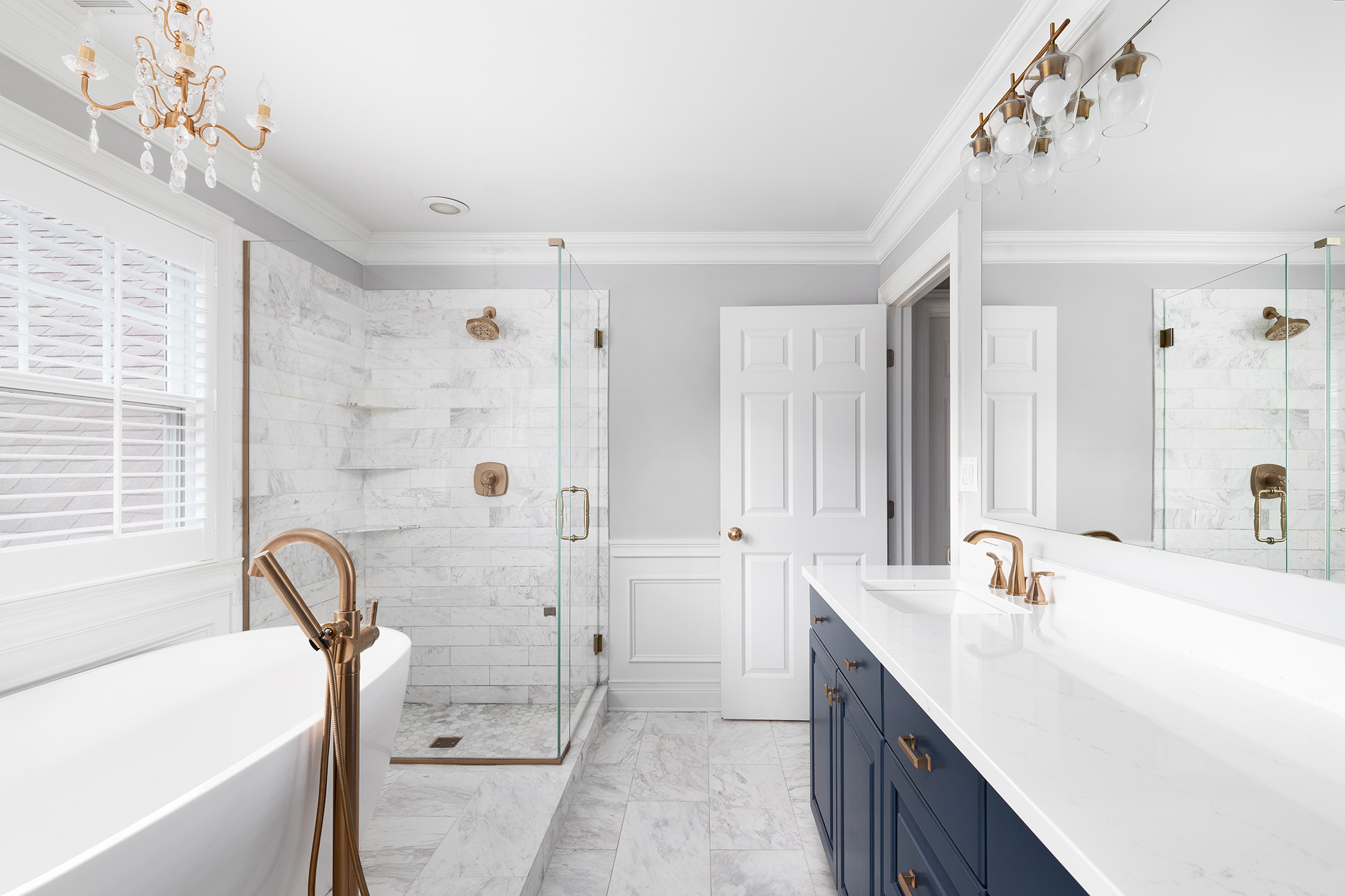 Elegant bathroom with marble tiles and navy blue vanity