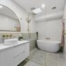 Modern bathroom with freestanding tub and glass shower enclosure