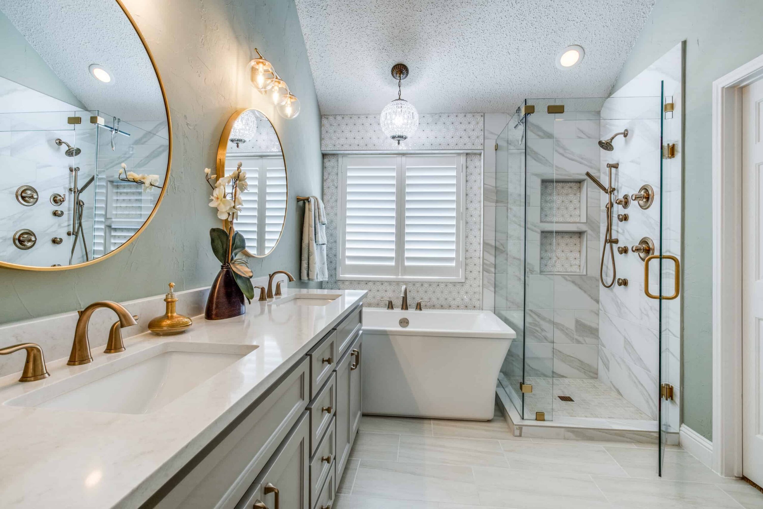 Modern bathroom with double vanity, freestanding tub, and glass shower enclosure