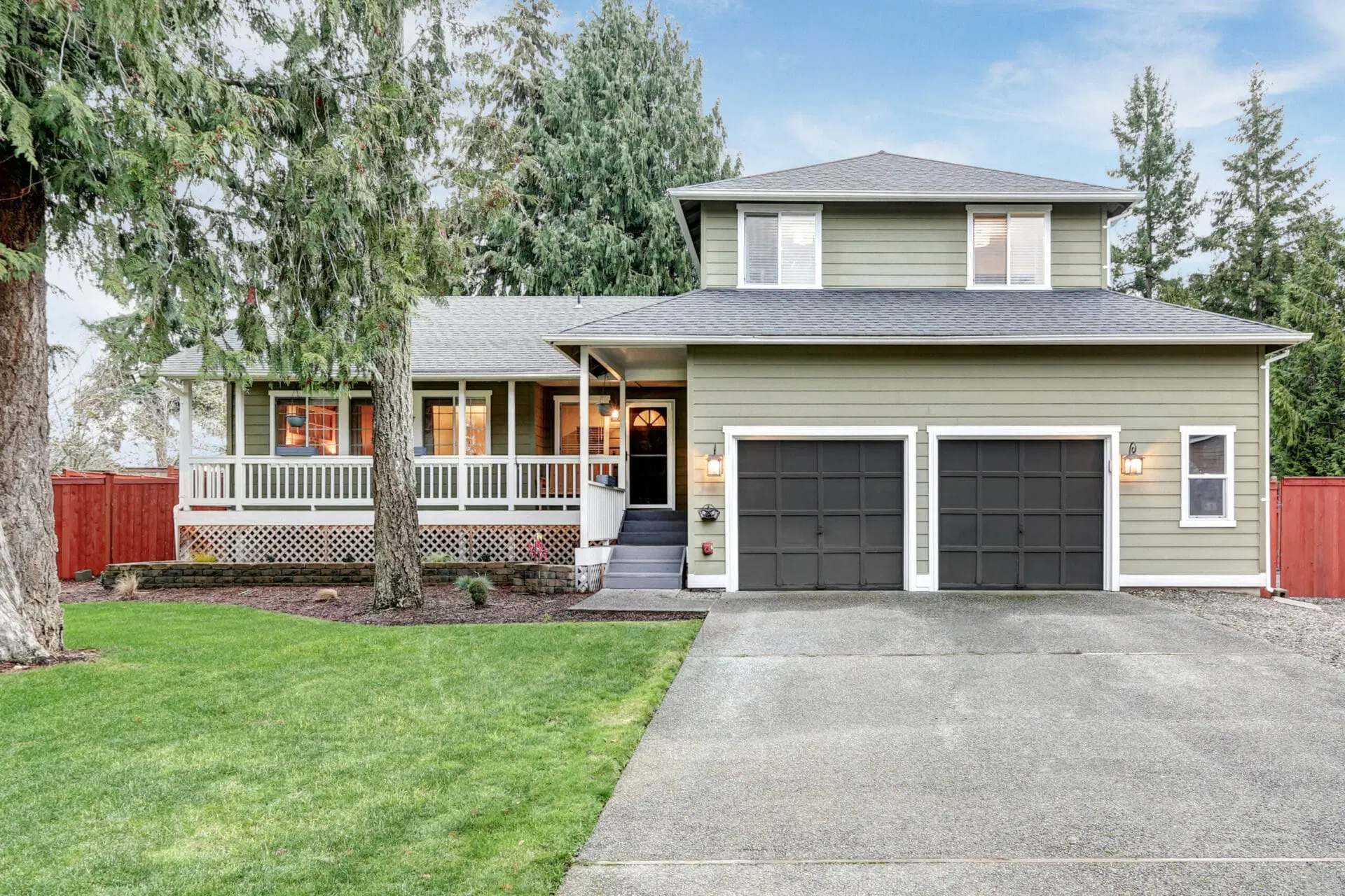  A renovated suburban house with a new second-story addition above the garage and front entrance.