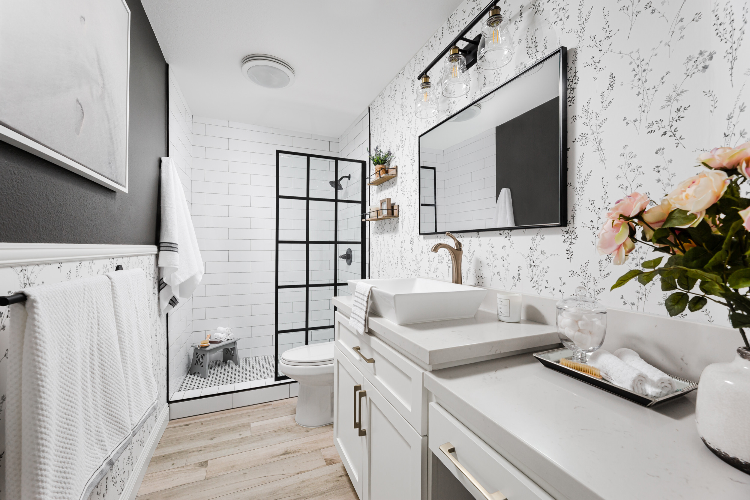 Stylish black and white bathroom with walk-in shower and modern vanity