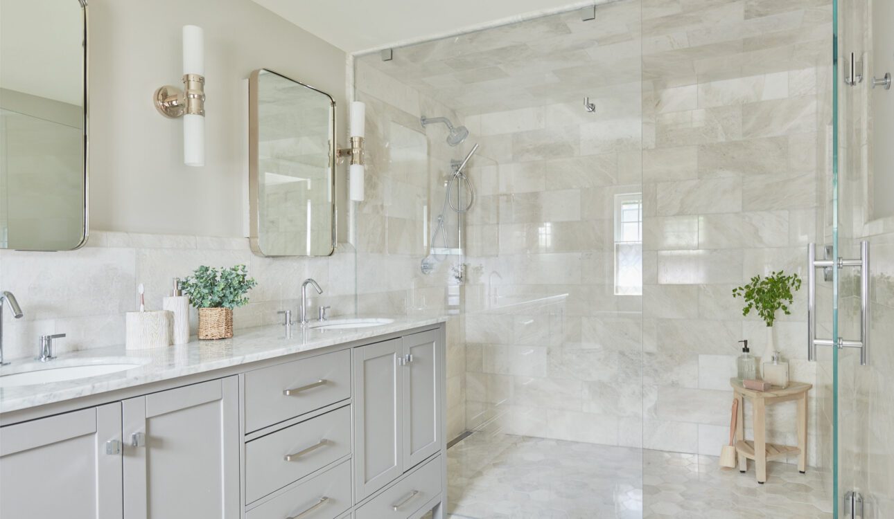 Elegant bathroom with double vanity and a large walk-in glass shower.
