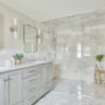 Elegant bathroom with double vanity and a large walk-in glass shower.