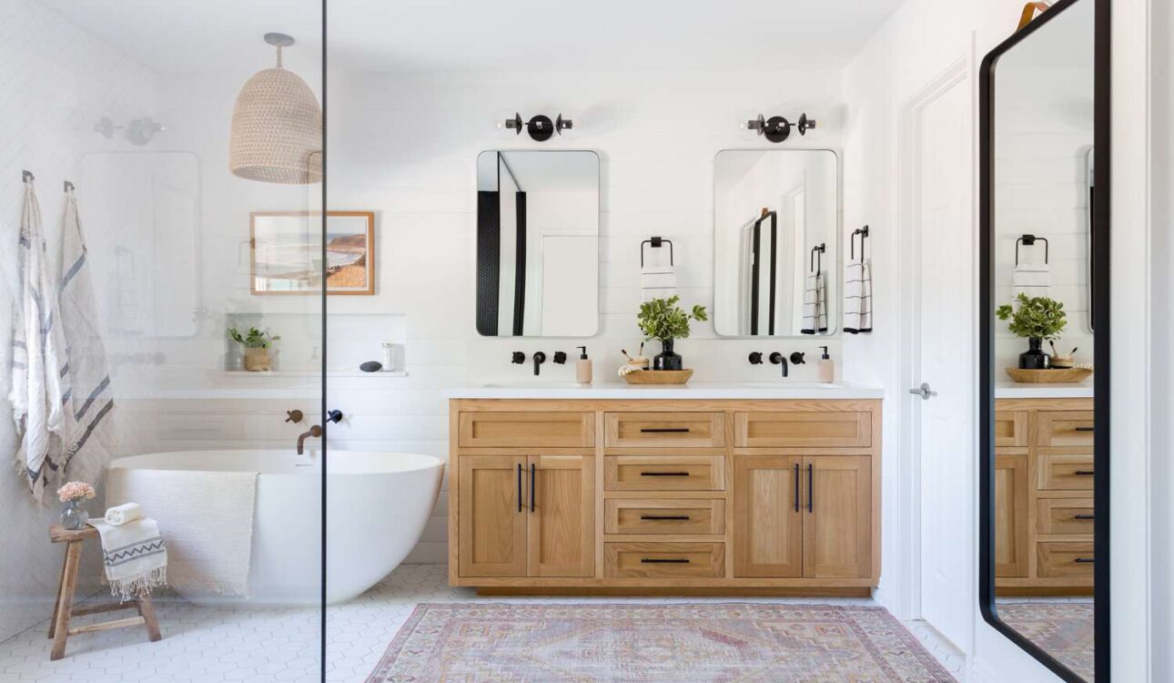 Bright bathroom with wooden vanity and freestanding bathtub