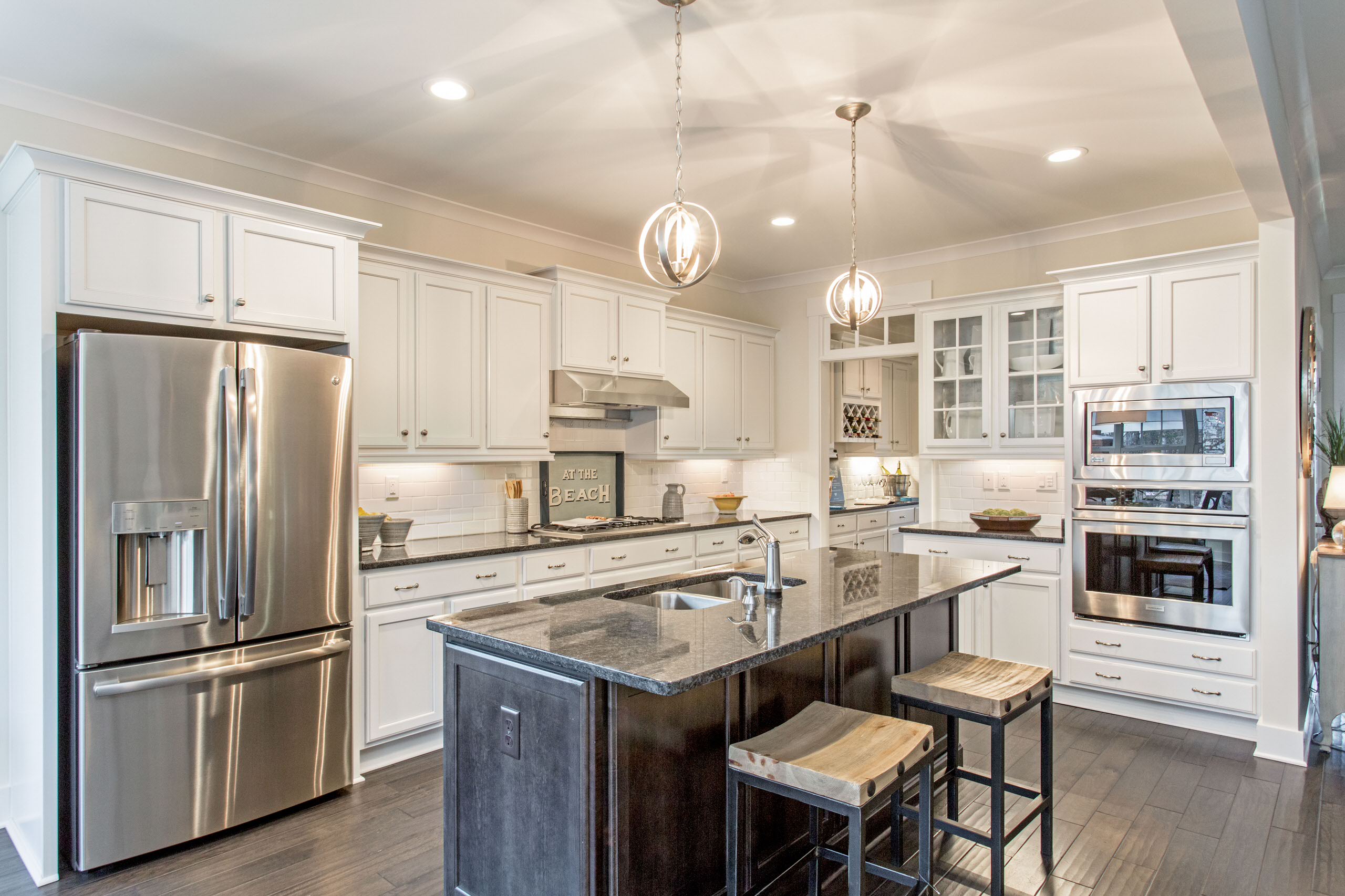 Spacious modern kitchen with stainless steel appliances and large island.