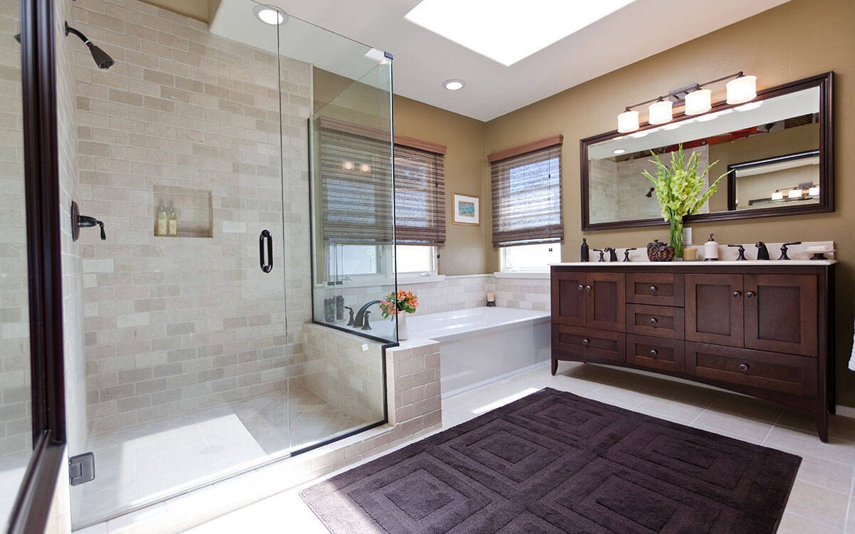 Traditional bathroom with glass shower, built-in tub, and dark wood vanity.