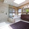 Traditional bathroom with glass shower, built-in tub, and dark wood vanity.