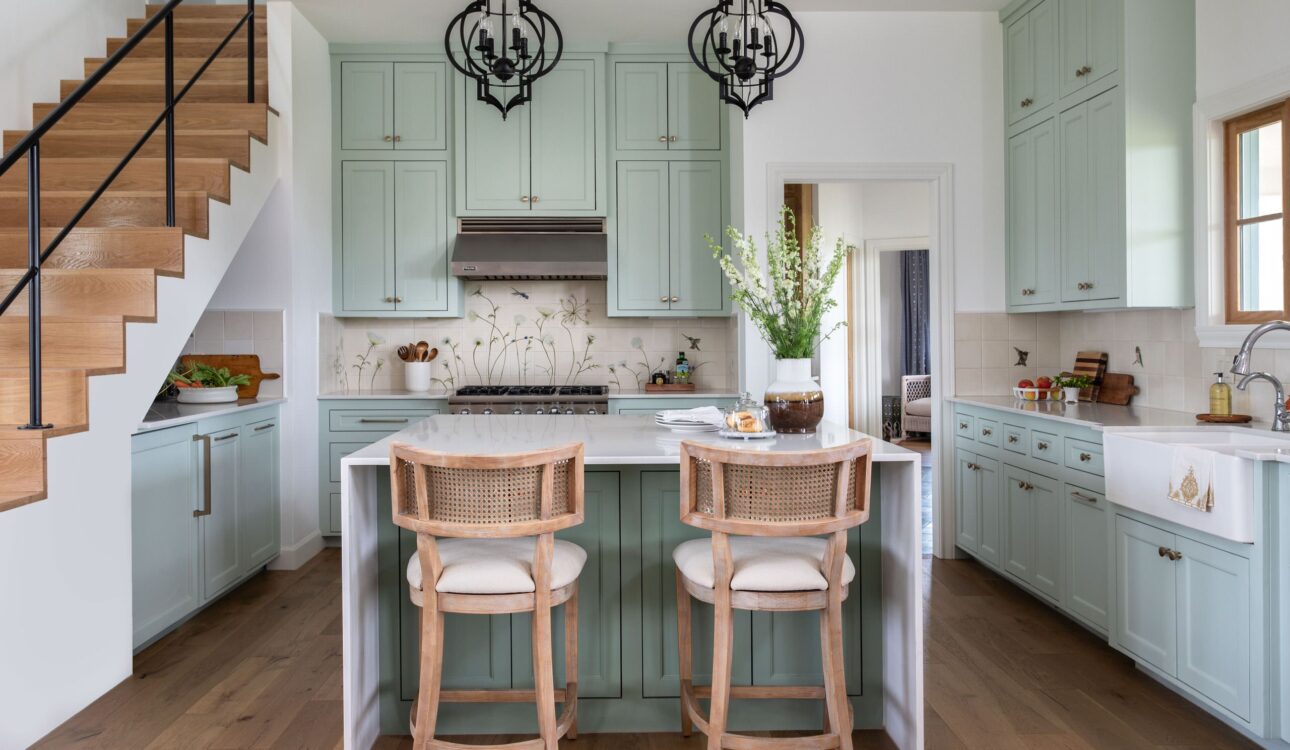 Farmhouse kitchen with mint green cabinets and a central island.