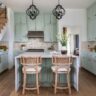Farmhouse kitchen with mint green cabinets and a central island.